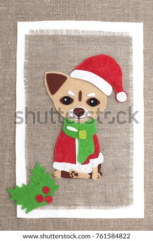 Greeting card with a dog in Santa costume from felt