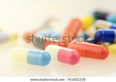 Oral medication background with warm light.Colorful of oral medications on White Background.