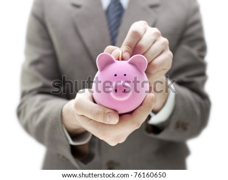 Businessman putting coin into the piggy bank Royalty-Free Stock Photo #76160650