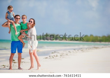 Happy beautiful family with kids together on tropical beach during summer vacation