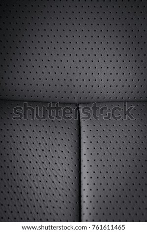 Part of black  leather car seat detail 