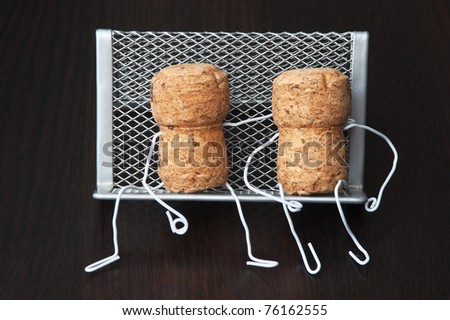 two wine corks are sitting on a bench