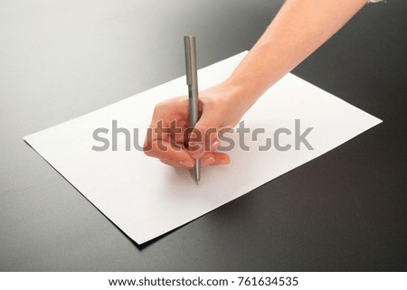 Female hands with paper on a black background. studio isolate