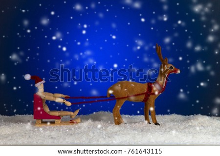 Santa Claus on sled with reindeer