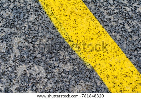 Fresh asphalt as abstract background and yellow road markings