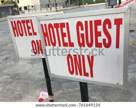 hotel guest only sign on street