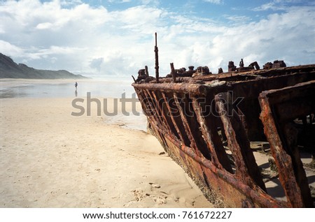 The rusted hulk of a ship on Fraser Island, Australia Royalty-Free Stock Photo #761672227