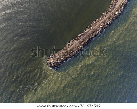 Aerial view over Ventspils pier entrance to the Baltic sea in Latvia, during summer time.