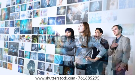 Group of people watching at a lot of pictures. Internet of Things. Information communication technology. Royalty-Free Stock Photo #761685295