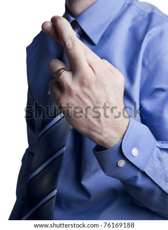 business man in a blue shirt and tie with crossed fingers for good luck