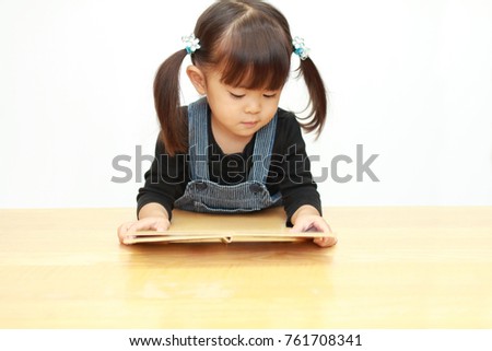 Japanese girl reading a picture book (3 years old)