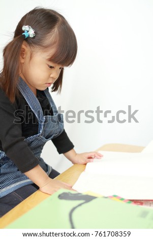 Japanese girl reading a picture book (3 years old)