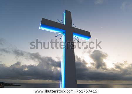 Neon cross on the sky background, cross against blue sky