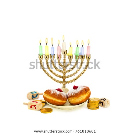 Menorah with candles, donuts, golden chocolate coins and wooden dreidels with red, blue, black letters on white background with space for text. Jewish holiday Hanukkah.