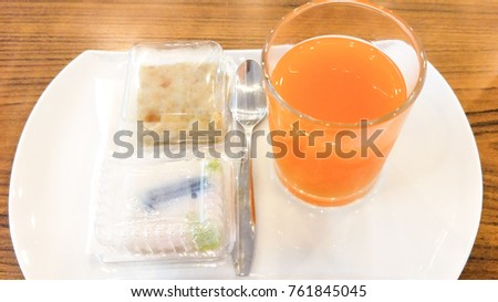 Orange juice with sweets on the table.