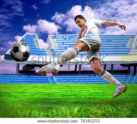 Happiness football player after goal on the field of stadium under sky