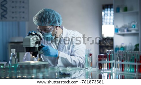 Laboratory worker carefully exploring samples to detect chronic pathologies Royalty-Free Stock Photo #761873581
