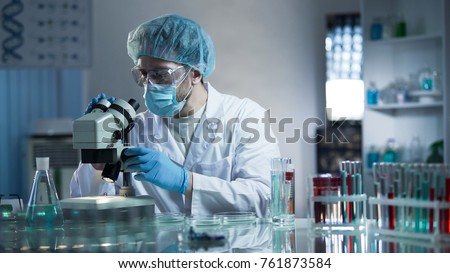 Lab assistant studying samples to detect pathologies, quality medical research Royalty-Free Stock Photo #761873584