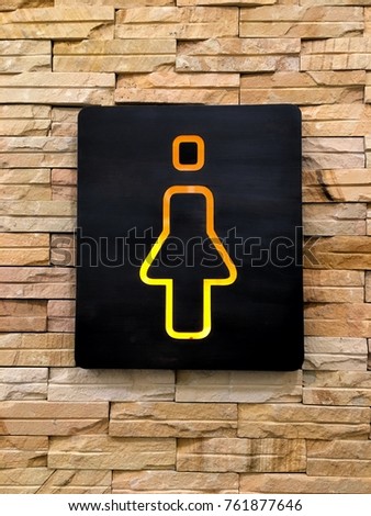 Toilet sign and direction on stone wall background