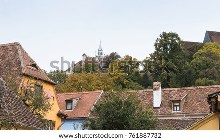 View of the old city over the roofs of houses in the city of Sighisoara in Romania
