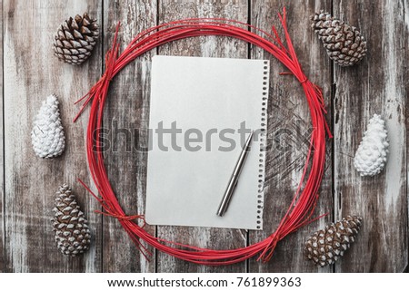 Old wooden background. Pine cones. Red decorative circle. Space for message Xmas, Christmas and New Year. Letter to Santa.Xmas and Happy New Year composition. Flat lay, top view
