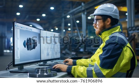 Inside the Heavy Industry Factory Industrial Engineer Works on the Personal Computer Designing Turbine/ Engine in 3D, Using CAD Program. Royalty-Free Stock Photo #761906896