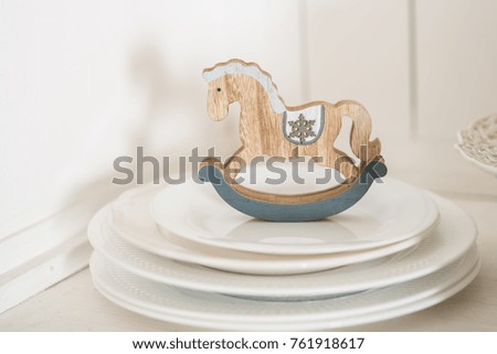 The toy horse on the plates