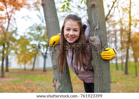 A girl between two trees in the park