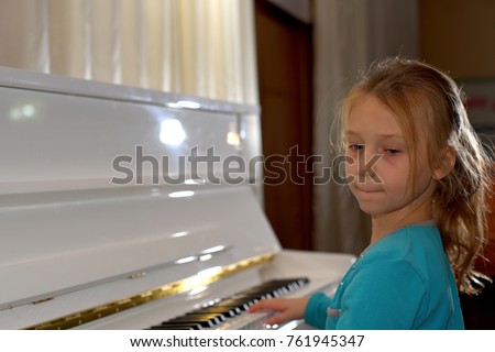 Hands on the white Keys of the Piano Playing a Melody. Women's Hands on the Keyboard of the Piano, Playing the Notes Melody. Hands of young Girl, Music on the Piano