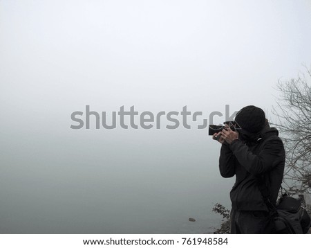 Photographer taking pictures at the lake