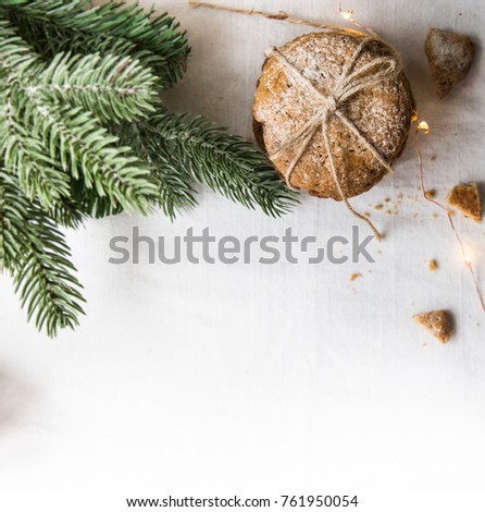 Homemade cookies on a white tablecloth,Christmas tree branches and lights