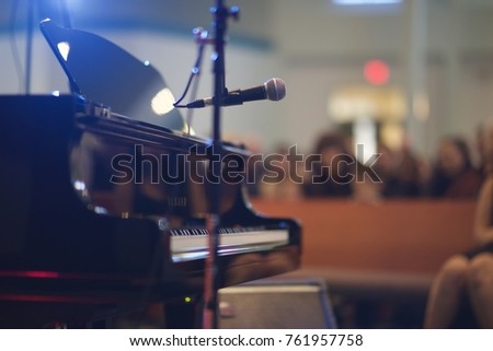 Recital Music Performance large venue with Grand Piano and microphone. Shot from back of stage.  Royalty-Free Stock Photo #761957758