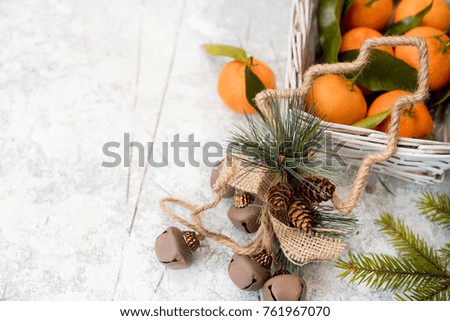 Christmas mandarins in the basket. On a white textured background. Place for your inscription