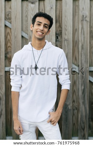 Young Middle Eastern Male Model Posing in All White against Wood Background