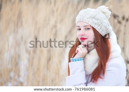 Attractive young woman on a sunny winter day, walking, snowy day
