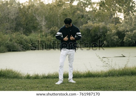 Young Male Model Posing by the Pond Outside