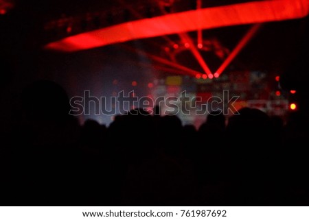 texture blur scene multicolored lights and smoke in concert with silhouettes of peopleBackground for design, blur texture, actors on stage