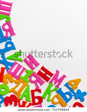 Colored letters and numbers made of plastic on white background