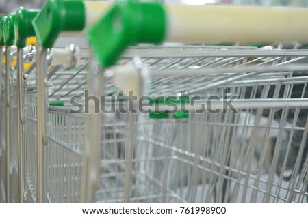 A metal shopping cart in a supermarket close-up.