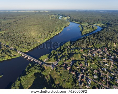 Aerial view over Merkys river valley, near Merkine town, Lithuania. During sunny summer season, surrounded by pine tree forest.