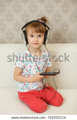 little girl listening to music