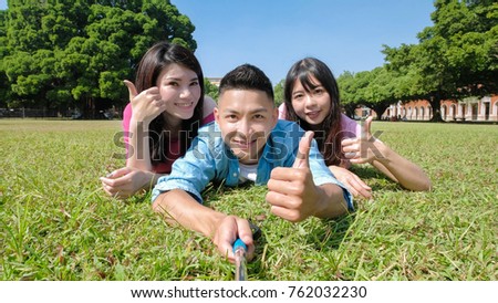Happy young people smile and selfie happily by stick 