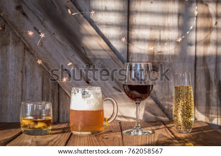 variety of alcoholic drinks on rustic wood background