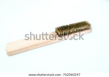The brass brush with wooden handle. 