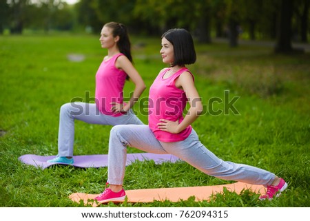 Two young woman doing gymnastic exercises outdoor