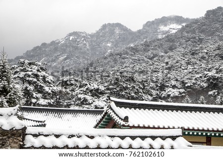 Beautiful winter landscape with snow covered trees and Asian temple 