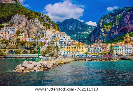 Wonderful Italy. The small haven of Amalfi village with a turquoise sea and colorful houses on the slopes of the coast Royalty-Free Stock Photo #762111313