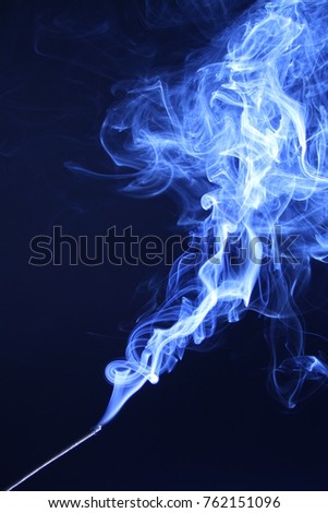 Blue abstract smoke on the dark background