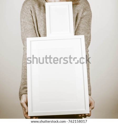 Woman's holding a blank picture frames
