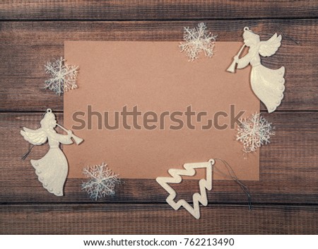 Christmas and New year background. A sheet of vintage paper with decorative elements on wooden surface. Empty space for your message.